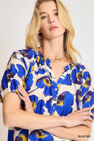 Woman wearing a blue floral dress against a white background